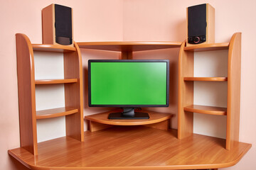 Background in the form of a computer desk with a monitor and sound speakers.