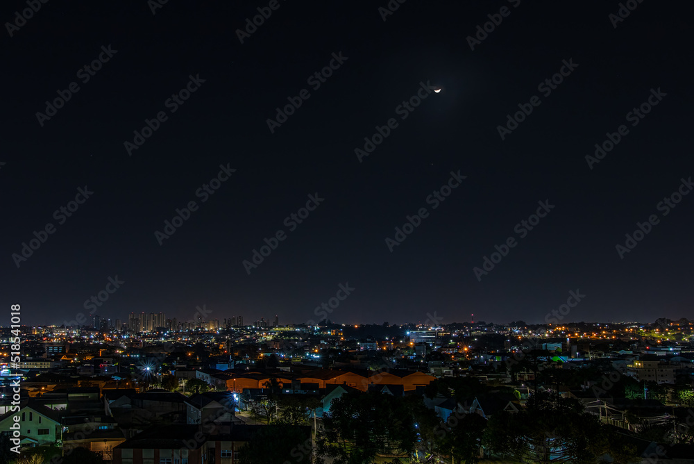 Wall mural the waning moon over the quiet town