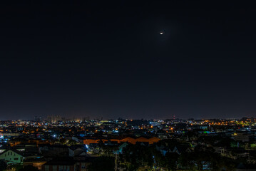 The waning moon over the quiet town
