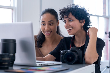 Female photographers using laptop