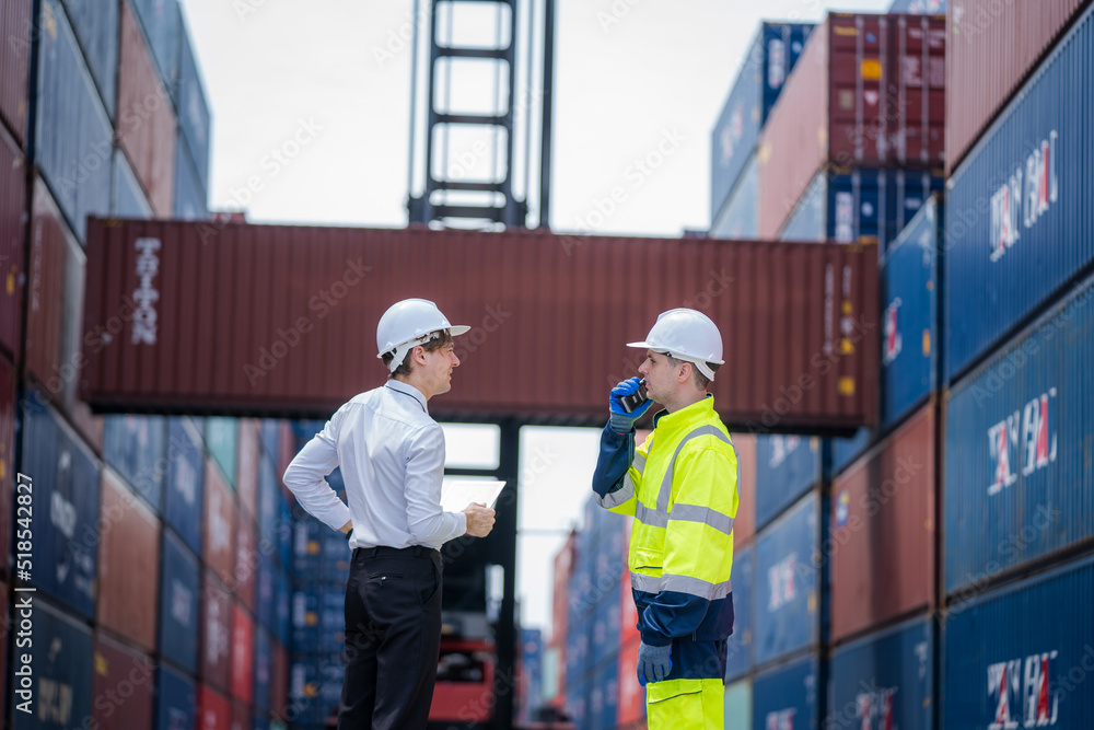 Poster businessman having discussion with the manager at container yard warehouse,manager and customer chec