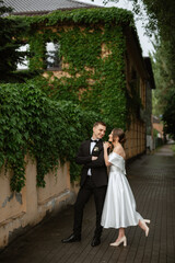 young couple bride and groom in a white short dress