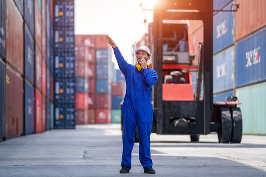 Container Yard Worker Checking Container At Container Yard Warehouse,Logistics Transportation And Shipping Business Concepts.