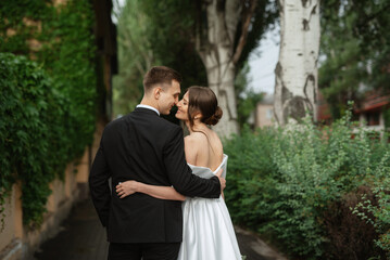 young couple bride and groom in a white short dress