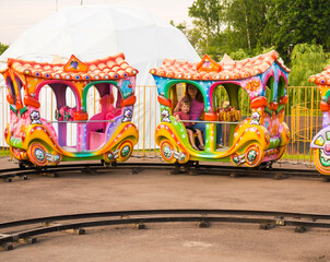 Children's colorful steam locomotive. Walk in the children's recreation park.