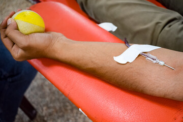 Blood donor at Blood donation camp held with a bouncy ball holding in hand at Balaji Temple, Vivek...