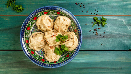 Traditional manti food on plate, top view. The concept of oriental cuisine. Uzbek food manty...
