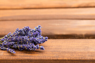 Bouquet of lavender flowers on a wooden background. Place for text. Selective focus.