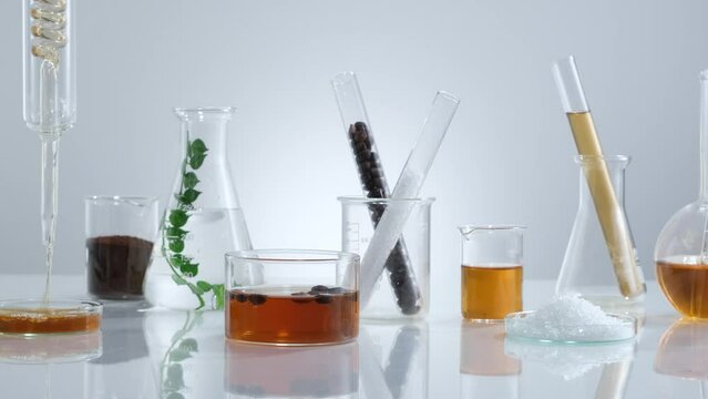 Coffee extract research for benefit of health and skin care , laboratory equipment beaker test tube brown liquid , science content