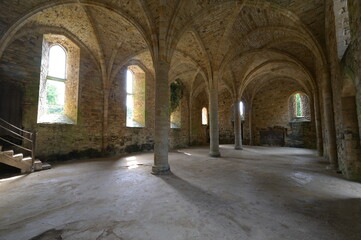 The inside of a Medieval Abbey on a sunlit summer morning.