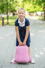 Beautiful child girl with backpack goes to school. Concept of back to school, education