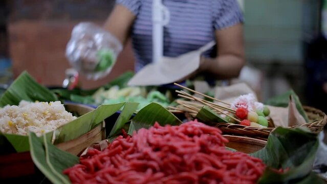 Traders in the market selling traditional snacks, Balinese Indonesian Traditional Snacks, Traditional Cake, Rice Cake in Night Market, Bali, Indonesia, Jajanan Pasar, Jajan Pasar