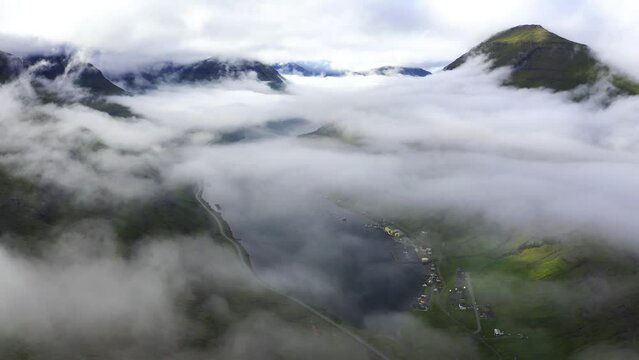 Aerial of fjord with low clouds in Faroe Islands