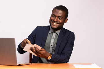 african businessman holding an envelope containing money