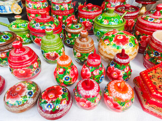 Fototapeta na wymiar Russian folk crafts - painted wooden jars and caskets