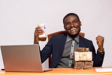 african businessman with lots of money rejoices