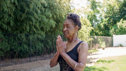 Senior woman doing yoga outdoors