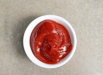 Ketchup tomato sauce on gray background