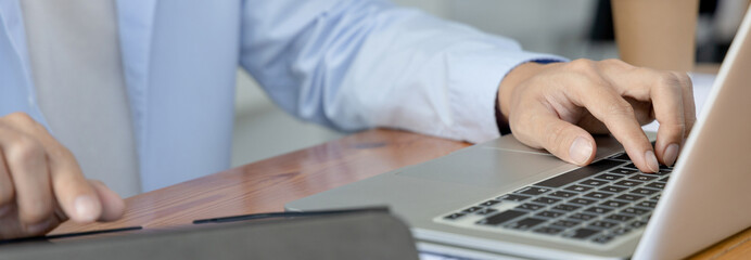 Financial or accounting professionals use  laptop and tablet to analyze the company's revenue-expenses graph to prepare for presentation to the chief executive and partner, Business data analysis.