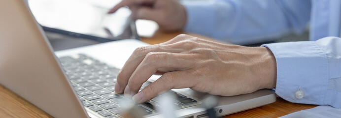 Financial or accounting professionals use  laptop and tablet to analyze the company's revenue-expenses graph to prepare for presentation to the chief executive and partner, Business data analysis.