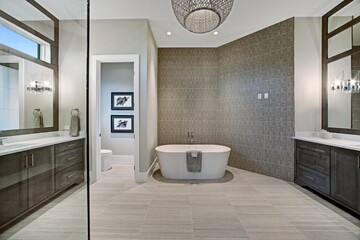 Modern Bathroom with Big Mirrors and Earth Tones. Glass Shower Door Showing in the Foreground