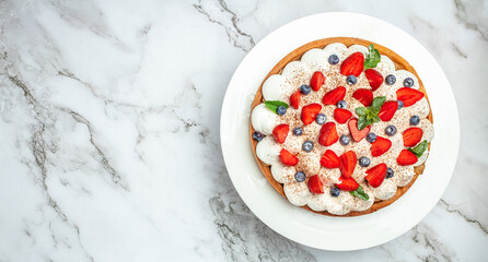 fresh fruit dessert. Strawberry shortcake tart pie pies on rustic wooden table, sugar powder in a freeze motion of a cloud of powder midair. Long banner format