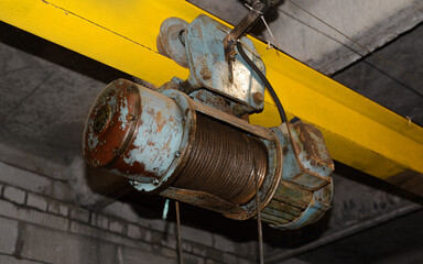 Electric hoist industrial equipment in garage. Electrically powered overhead hoist, provides...