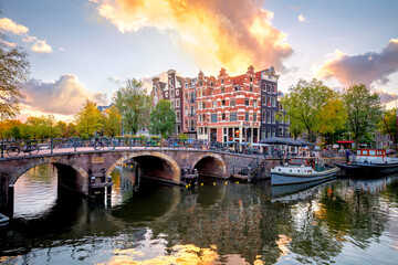 Amsterdam. PHolland. Downtown of Amsterdam. Traditional houses and bridges of Amsterdam. A colorful sundown time.