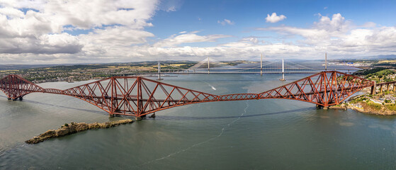 The drone aerial view of  the Forth Bridges and the new Queensferry Crossing. The Forth Bridge is a...