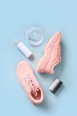 Concept washing sport sneakers with brush and special tool for cleaning them on blue background.
