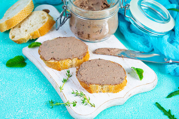 Sandwich with chicken liver pate on blue background