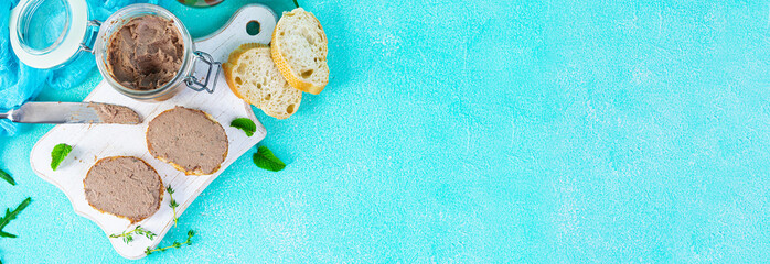 Sandwich with chicken liver pate on blue background. Top view