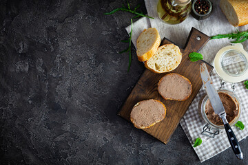 Sandwich with chicken liver pate on dark background. Top view
