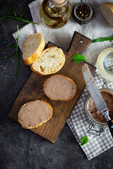 Sandwich with chicken liver pate on dark background