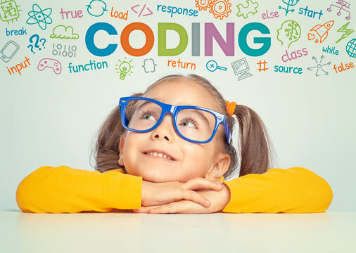 Beautiful cute little girl with eyeglasses looking at colorful CODING word, symbols and commands above her head.  Kid programmer learn coding. Programming languages concept. 