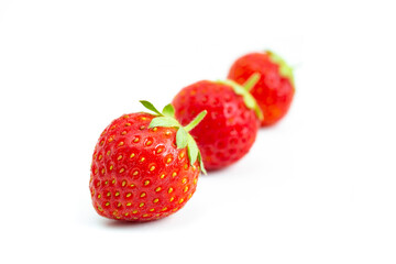 Strawberries isolated on white background. Still-life picture taken in studio with soft-box.