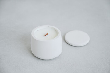 Fototapeta na wymiar White Candle in Plaster Cache-pot, Lid is Close-up. Place for Label. Scented Candle Handmade.