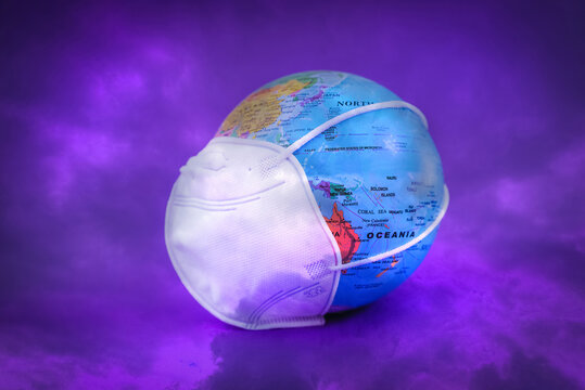 World Planet Earth Globe With Protective Face Mask On The Purple,veri Peri Color Clouds.World Medical Concept.double Exposure