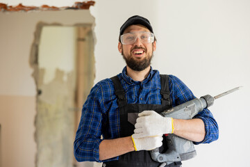Satisfied worker performs home bathroom demolition, general apartment renovation with hammer, tile...