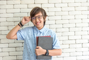 secondary chool boy student wearing glasses on reading book for final exams