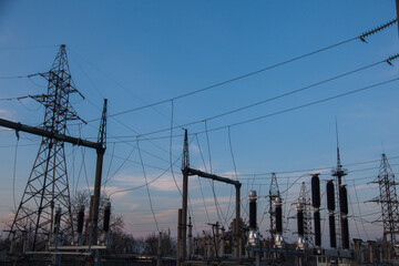 Powerful urban electrical substation with transformers and power lines.