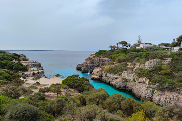 Fototapeta na wymiar Cala en Brut beach, Menorca (Minorca), Spain. Lovely bay and beach Cala'n Brut. Popular place to jump into water from rock shelves