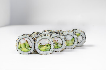 Sushi roll california in sesame seeds with shrimp.