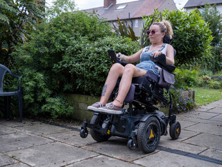 Fototapeta na wymiar Woman in electric wheelchair outdoors