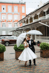 Obraz premium young couple bride and groom in a white short dress