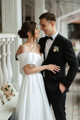 young couple bride and groom in a white short dress