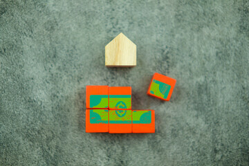 The concept of save money to buy home, complete wood block with money icon