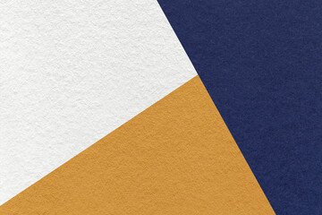 Texture of craft navy blue, white and ocher shade color paper background, macro. Vintage abstract...