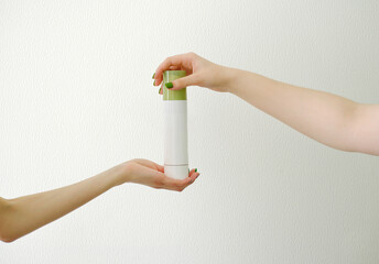 Hands models holding a cosmetic jar with a white background for cosmetic advertising