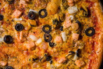 Pizza with olives, salmon, squid, mussels, cheese
